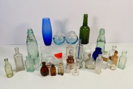 Vintage glassware to include Codd-neck bottles, eye baths, fishing floats,