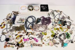 A quantity of costume jewellery to include necklaces, bracelets, brooches and similar.