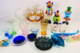 A quantity of art glass pieces comprising Murano clowns, vases to include Caithness,