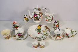 A collection of Rob Turner Bone China pieces to include teapot, sugar bowl, two cups, two mugs,