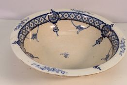 A Corona Ware wash bowl decorated in blue and white with gilt highlights.