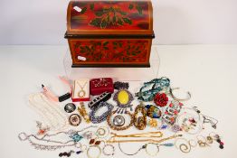 A jewellery casket containing a quantity of various costume jewellery.
