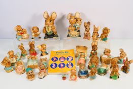 A collection of Pendelfin rabbit figures including two large examples and a Collector's Handbook,