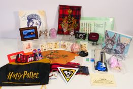 A mixed lot to include military related items, Harry Potter bag, small white metal horse figure,
