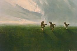 A framed print depicting three galloping horses in a landscape setting,