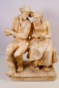 A large cast plaster figure group depicting an elderly lady and gentleman seated on a bench,