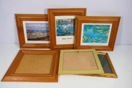 A collection of picture frames, predominantly pine.