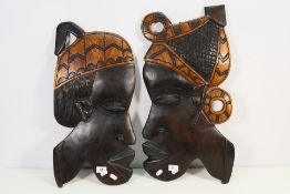 A pair of African carved wood wall plaqu