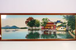 A large Chinese painting on silk lakeside landscape scene, framed under glass,