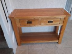 An oak console table with two short drawers, approximately 81 cm x 109 cm x 40 cm.