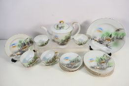 A collection of Japanese tea wares decorated with landscape scene.