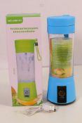 A NEW Sky Blue portable and rechargeable battery juice blender, Number HM-03, holds up to 380 ml,