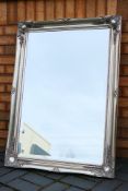 A large bevel edge wall mirror measuring