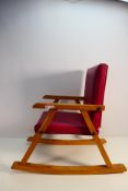 A child's rocking chair with leather effect upholstery.