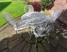 A cast metal garden table and four chairs, table approximately 66 cm x 86 cm.