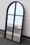 An arch top wall mirror, approximately 109 cm x 57 cm.