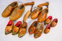 A collection of vintage wooden clogs, shoe stretcher and similar.