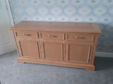 A sideboard with three drawers over three cupboards, approximately 76 cm x 149 cm x 48 cm.