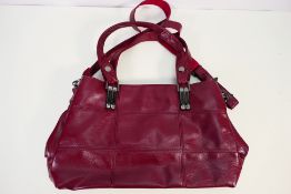 A leather handbag in burgundy with nicke