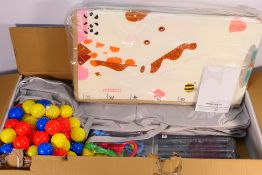 An unused playpen with accessories, boxed.