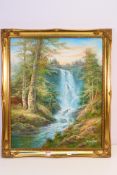 A gilt framed oil on canvas landscape scene depicting a waterfall in a forest setting,