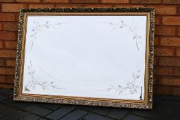 A gilt framed, bevel edge wall mirror wi