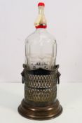 An etched glass Co-Operative Wholesale Society Ltd soda syphon and a plated bottle stand.