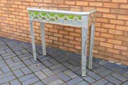 A mirrored console table measuring appro