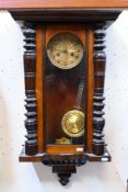 A Vienna style wall clock, Roman numerals to the dial, with key and pendulum,