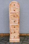 A slim dome top chest of seven drawers,