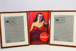 A framed jigsaw puzzle depicting a vintage advertising poster for Coca-Cola and two unused Ikea