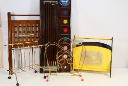 A quantity of vintage magazine racks and an antique Gee-Wiz game board.