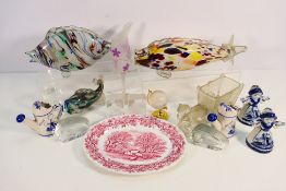 A collection of ceramics and glassware to include Delft, Murano style glass fish models,