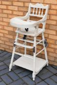 A child's vintage metamorphic high chair and stroller, 98 cm (h).