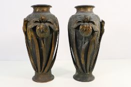 A pair of cast metal Japanese vases with applied floral decoration, signed to the base,