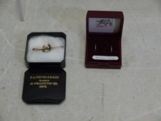 A pair of yellow metal ear hoops, stamped 9ct and a rose metal bar brooch with horseshoe motif,