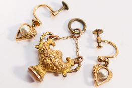 A yellow metal pendant, approximately 2.
