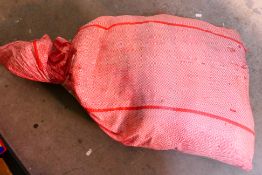 A sealed sack containing approximately 25 kg of unexamined, pre-owned,