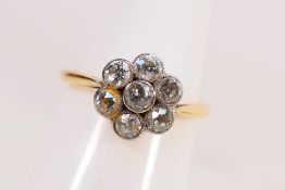 A yellow metal, stamped 18ct, diamond cluster ring,