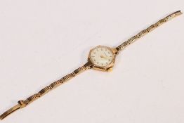 Garrard - A lady's 9ct gold cased wristwatch and bracelet, Arabic numerals to a signed dial,