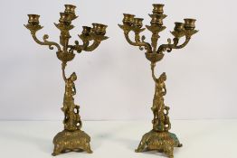 A pair of brass figural stem candelabra to accommodate six candles, approximately 42 cm (h).