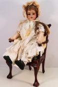 Simon & Halbig - An antique Simon & Halbig bisque headed doll measuring approximately 60 cm tall.