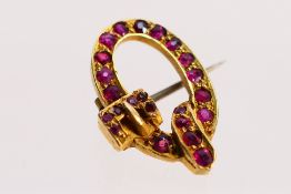 A yellow metal stone set brooch in the form of a belt, 1.9 cm (l), approximately 2.