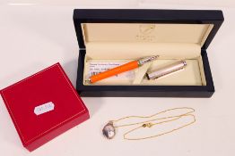 An Aspinal rollerball pen, stamped 925 and clad with orange lizard skin effect covering,