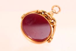 A 9ct rose gold swivel fob set with carnelian and bloodstone, Birmingham assay, approximately 9.