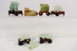 A group of Chinese jade or similar hardstone animal figures comprising a dolphin,