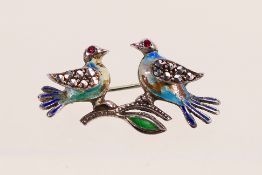A white metal (stamped Sterling) and enamel stone set brooch in the form of two birds, 3.6 cm (l).