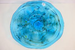 A large Italian glass shallow bowl or centrepiece with shaped rim,