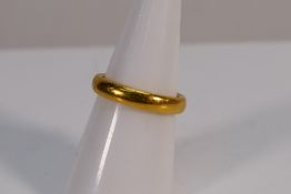 A 22ct gold wedding band, size M, approximately 6.4 grams.