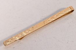 A 9ct rose gold tie clip, Birmingham assay, approximately 2 grams.